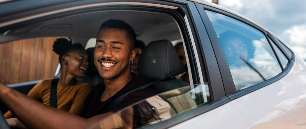 Friends smiling in car